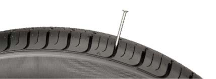 image of tire with nail in it